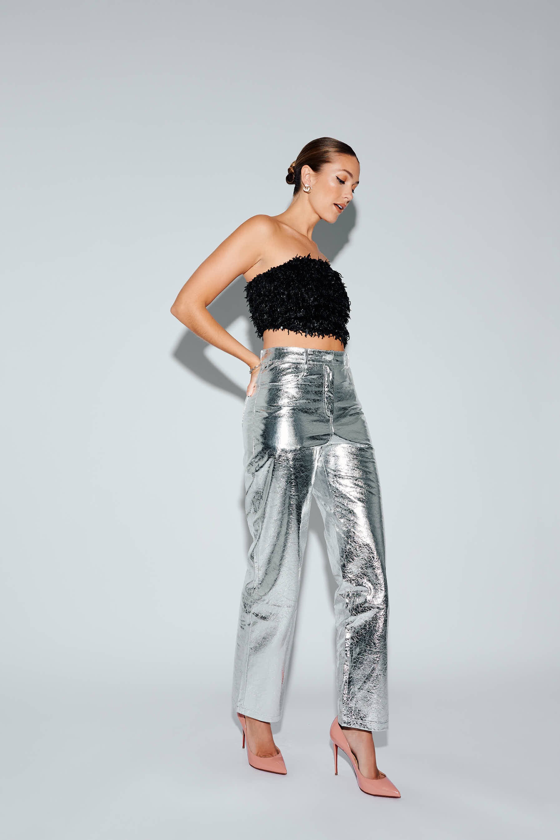 High waist silver faux leather pants with black feather crop top