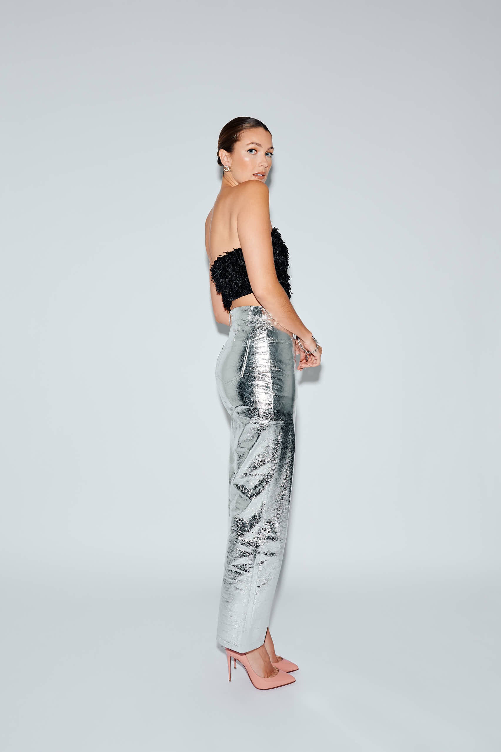 High waist silver faux leather pants with black feather crop top