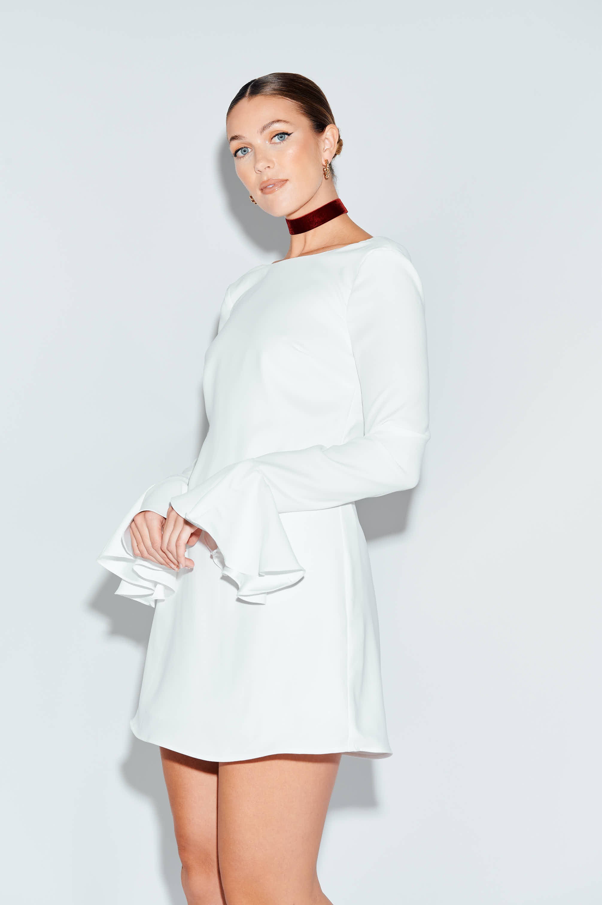 White mini dress with low back and bell sleeves